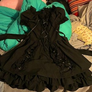 A black Lolita dress with ribbons that cross in the front and sides.